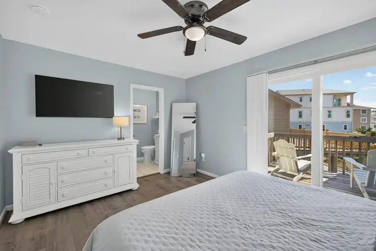 Primary bedroom with sliding doors to a private balcony